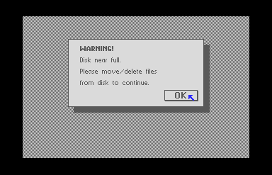 A GEOS dialogue box that reads: WARNING! Disk near full. Please move/delete files from disk to continue.